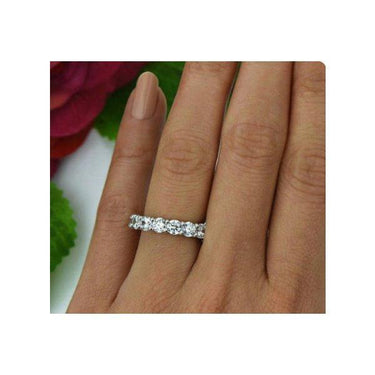 Model wearing 14K white gold eternity band made with H color and SI clarity diamonds.