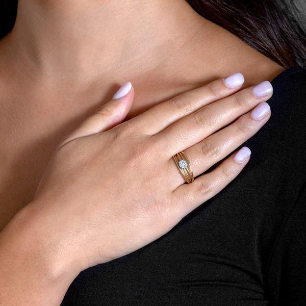 Model wearing 14K yellow gold and diamond fashion cluster ring with 0.05 ctw in diamonds.