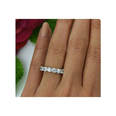 Model wearing 4 carat diamond ring eternity band made with I color and I clarity diamonds.